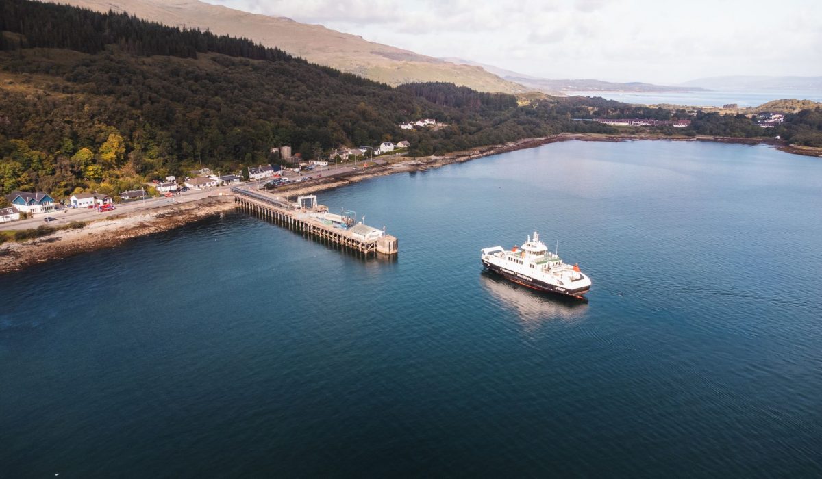 A ferry at a pier in the Scottish Highlands from the air