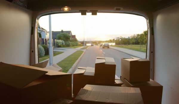 A removal van loaded with cardboard boxes at sunset