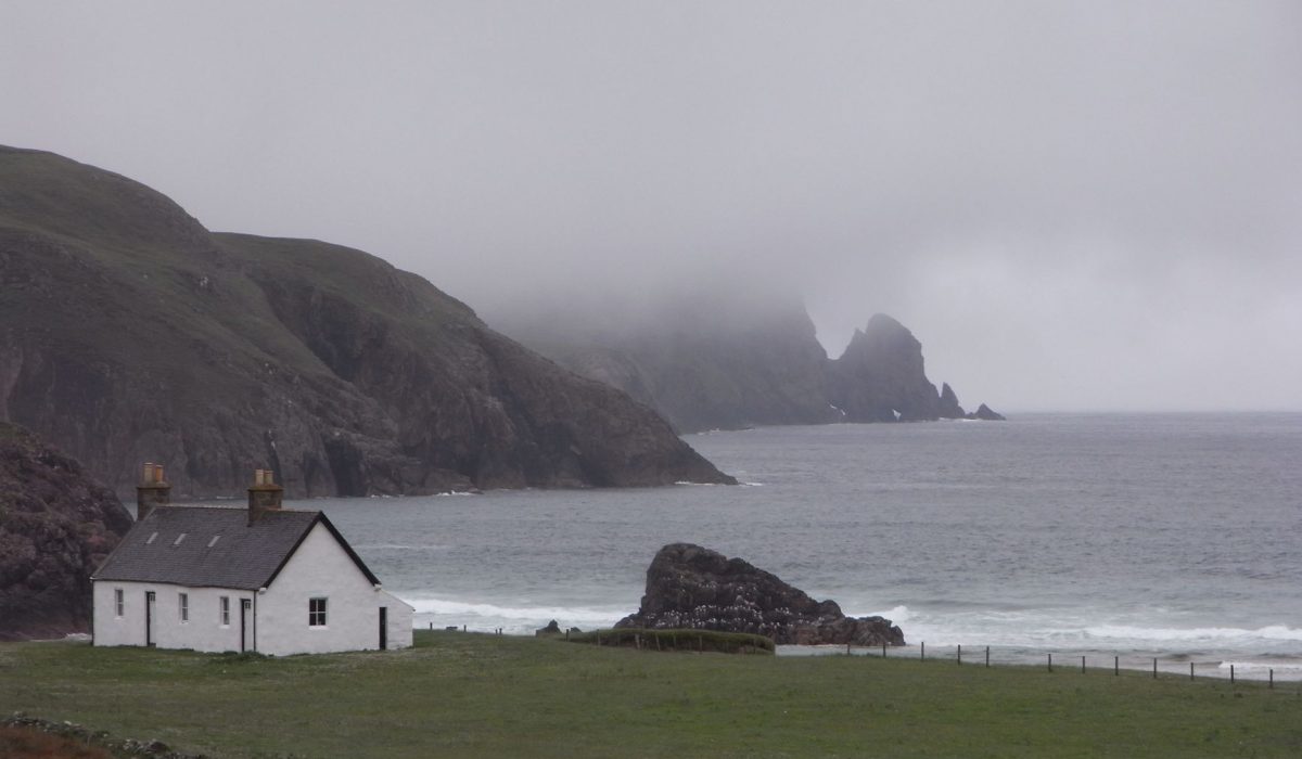 A lone cottage above the sea on the Scottish coast