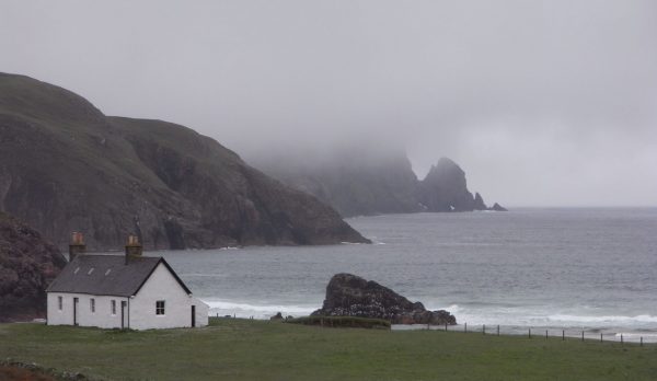 A lone cottage above the sea on the Scottish coast