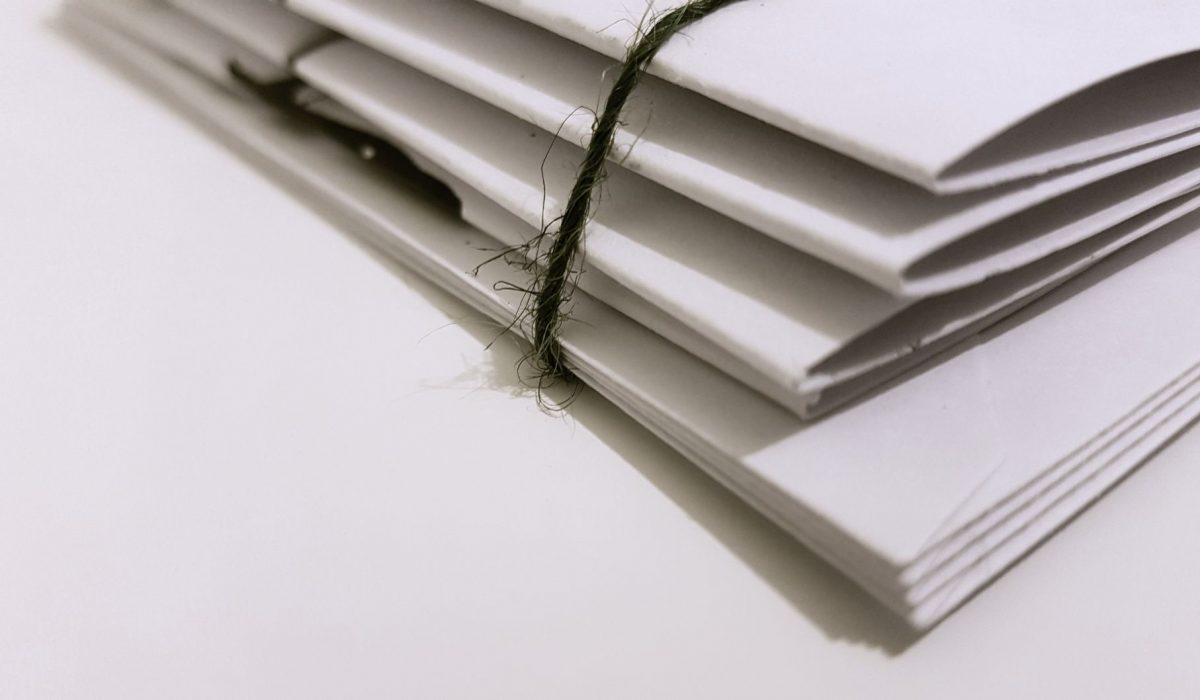 A pile of white envelopes tied with string