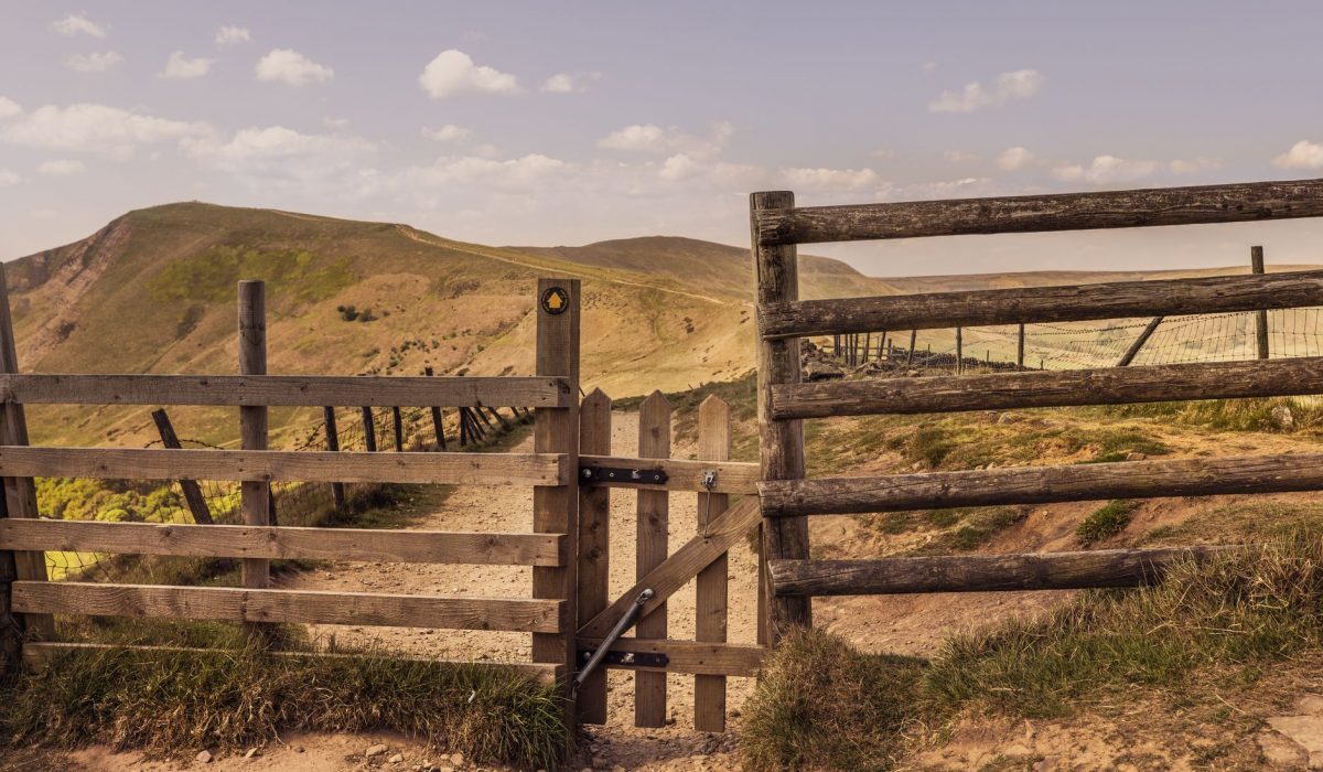 A wooden gate on a hill path