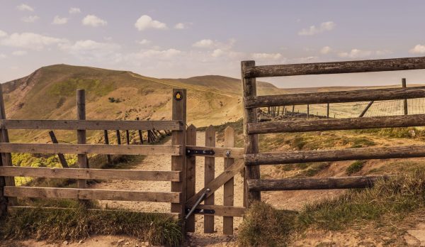 A wooden gate on a hill path