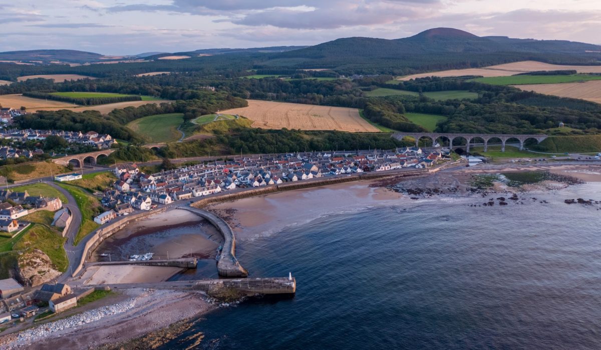 Drone shot capturing Cullen's picturesque coastline and landscape in Scotland