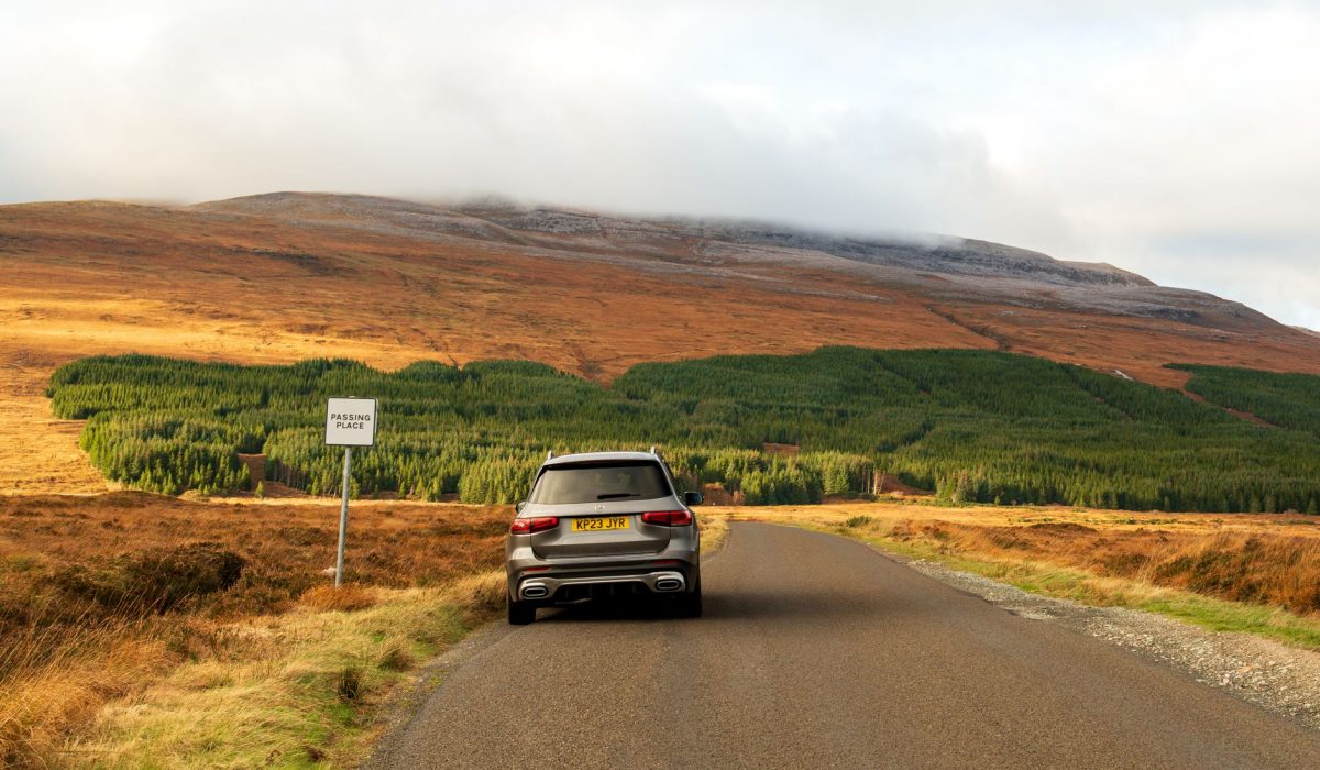 A Passing Place sign on a single-track Highland road in mist
