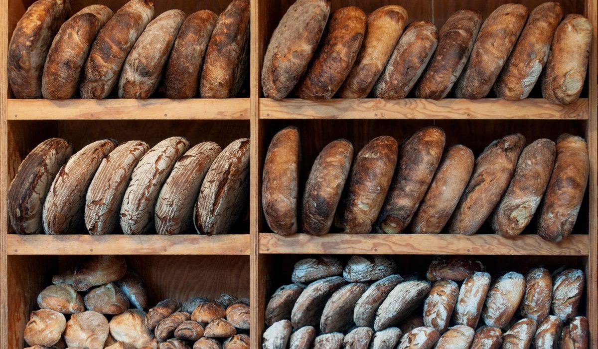Loaves of bread arranged on wooden shelves