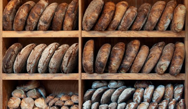 Loaves of bread arranged on wooden shelves