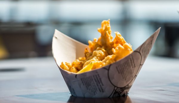 Delicious crispy fish and chips served in traditional paper, captured in Richmond, BC
