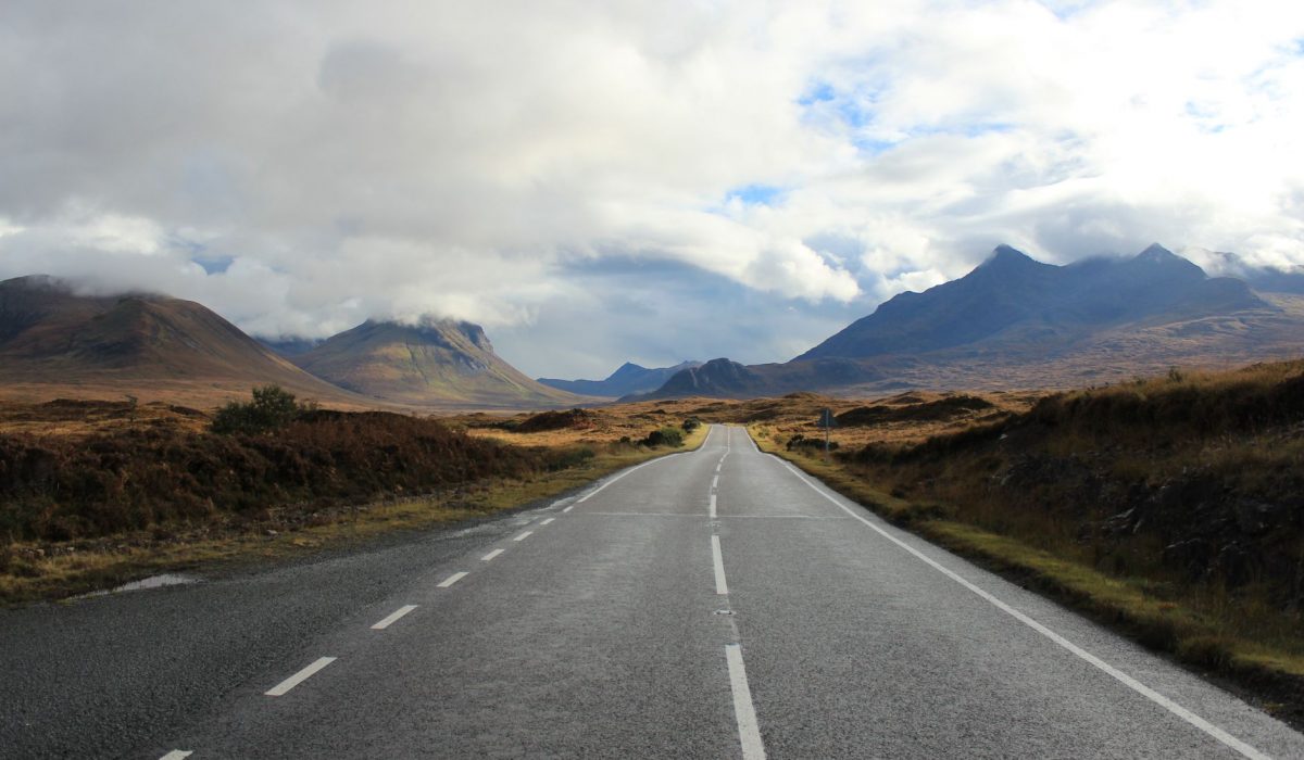 Empty road through dramatic Scottish Highlands landscape