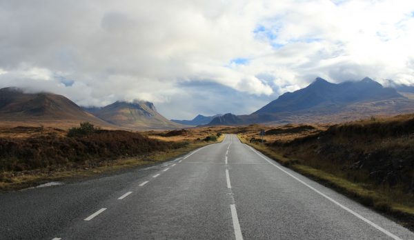 Empty road through dramatic Scottish Highlands landscape