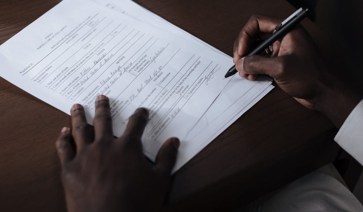 A hand signing official documents