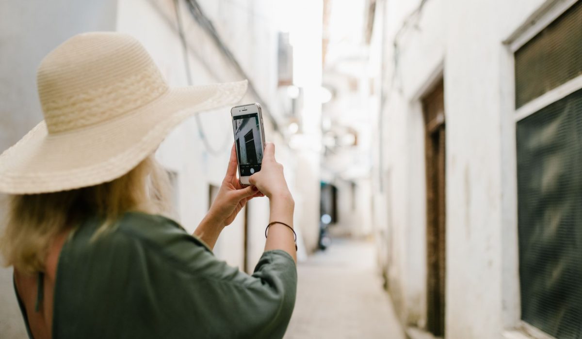 A visitor photographing an old stone building