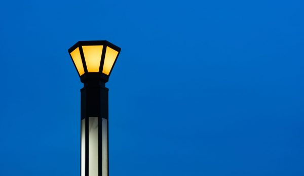 A single lit streetlamp against an evening sky